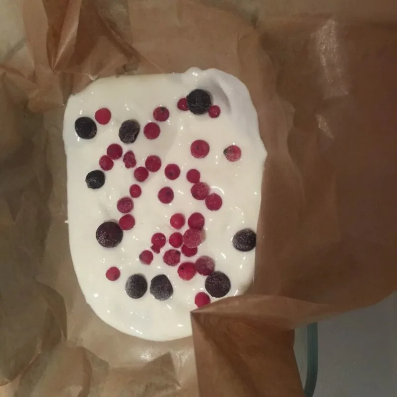 greek yoghurt in baking paper with added frozen fruits ready to make baby led weaning yogurt bark