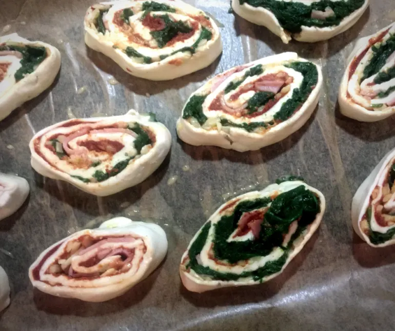 spinach, ham and cheese pinwheels sat on the counter before being baked