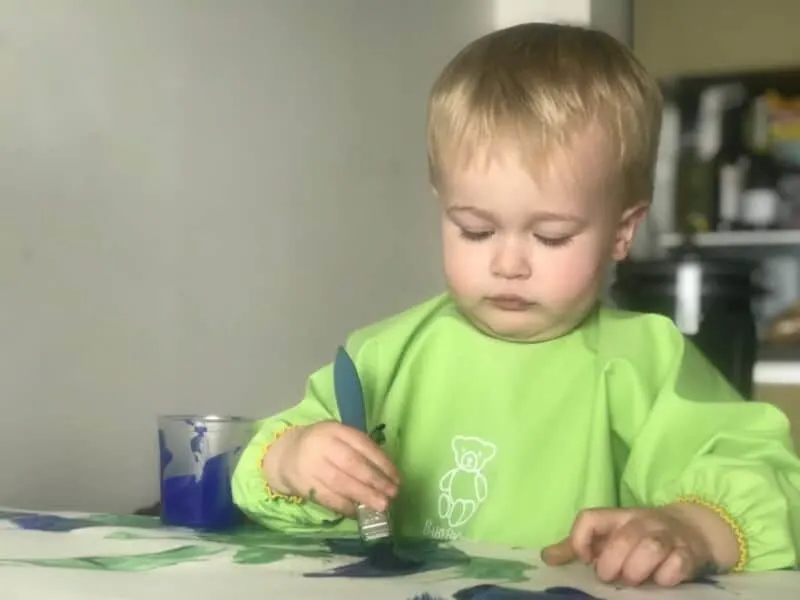 Dexter painting while wearing the Baby Bjorn long sleeved bib