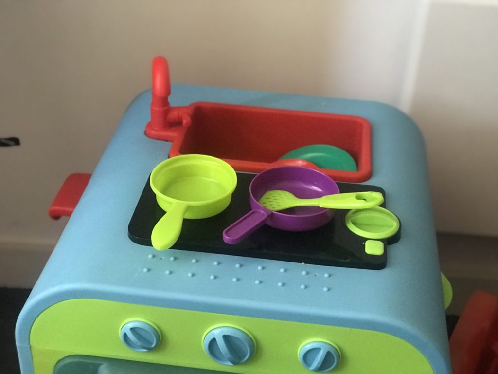 Dexter's toy kitchen with plastic pans and spatulas