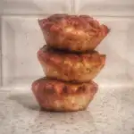 three broccoli and courgette muffins stacked neatly on top of each other