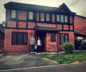 Nicola, her husband and toddler Dexter stood in front of their house which is a four bed detached property