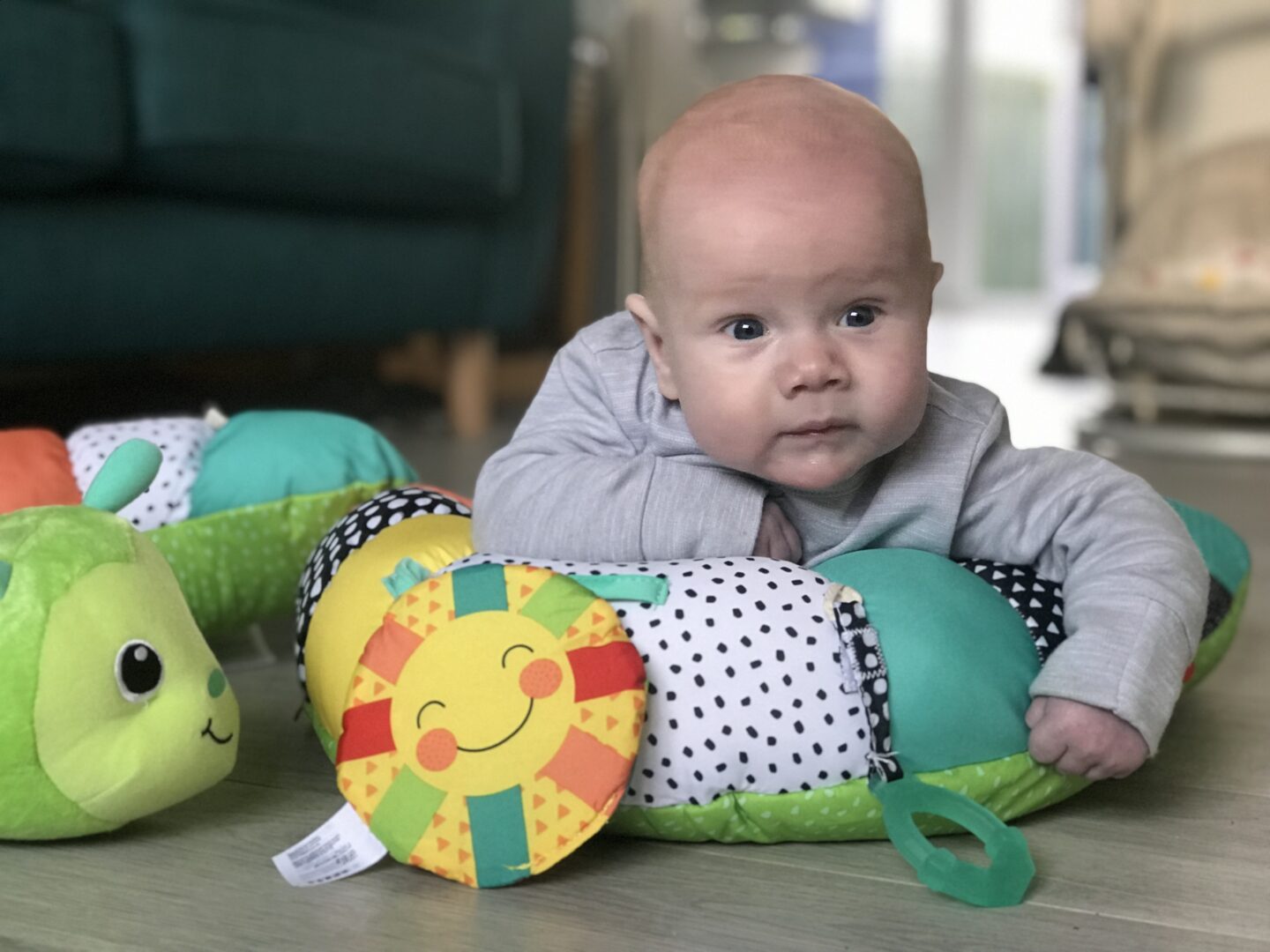 Felix using his Infantino Prop-a-Pillar tummy time support in the lounge