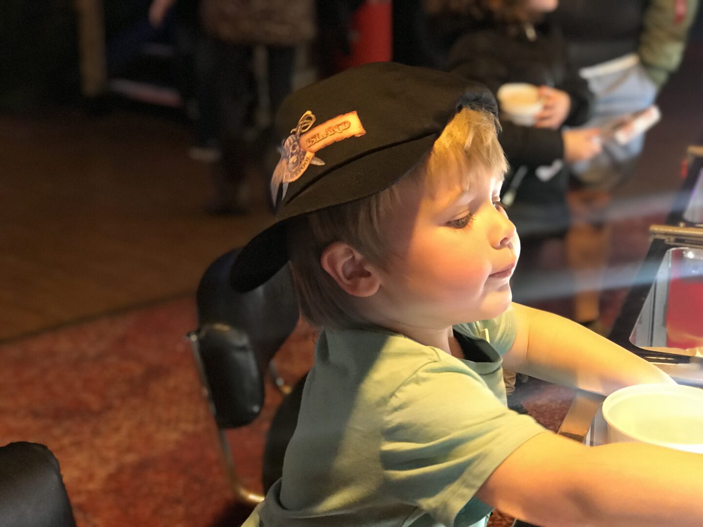 Dexter wearing a coral island hat, playing on the 2p machines