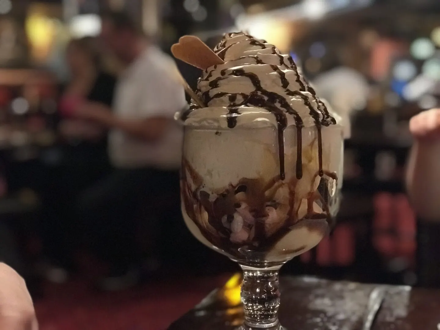 a shot of the giant sharing dessert with whipped cream, chocolate sauce, ice cream and brownies