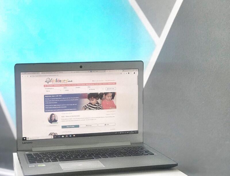 Laptop with childcare.co.uk on screen in front of geometric background