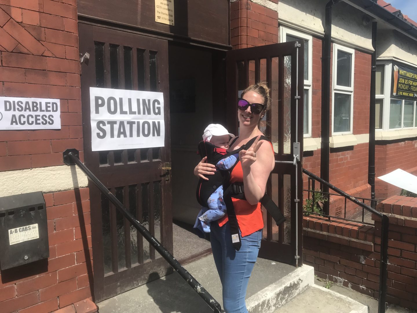 Nicola babywearing felix outside the polling station