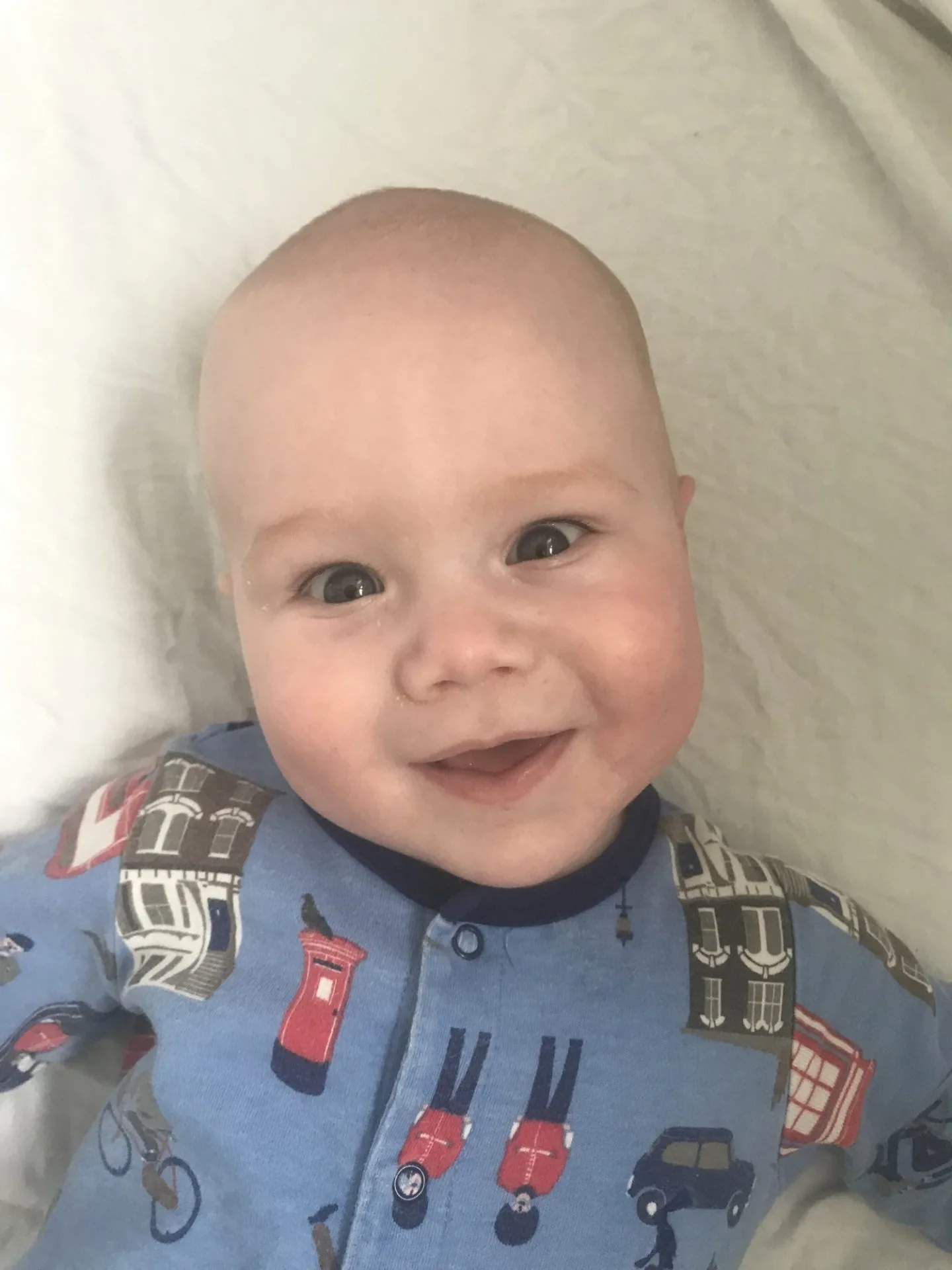 Felix smiling to the camera wearing a blue joules sleepsuit