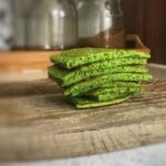 Baby Led weaning spinach pancakes on a chopping board in the kitchen