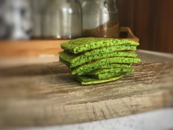 Baby Led weaning spinach pancakes on a chopping board in the kitchen