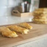 Baby Led weaning hash brown potato cakes on a tray cut into strips