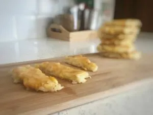 Baby Led weaning hash brown potato cakes on a tray cut into strips