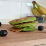 3 ingredient spinach and banana pancakes on a chopping board