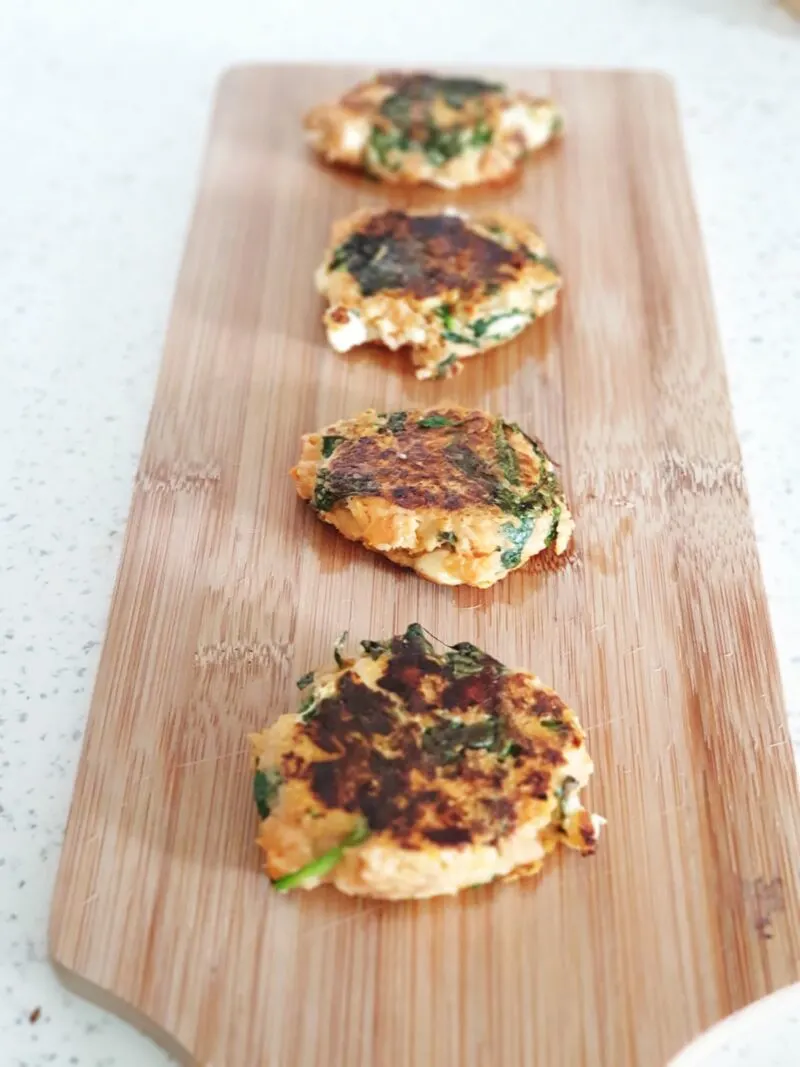 baby led weaning sweet potato and spinach burgers for babies on a wooden tray