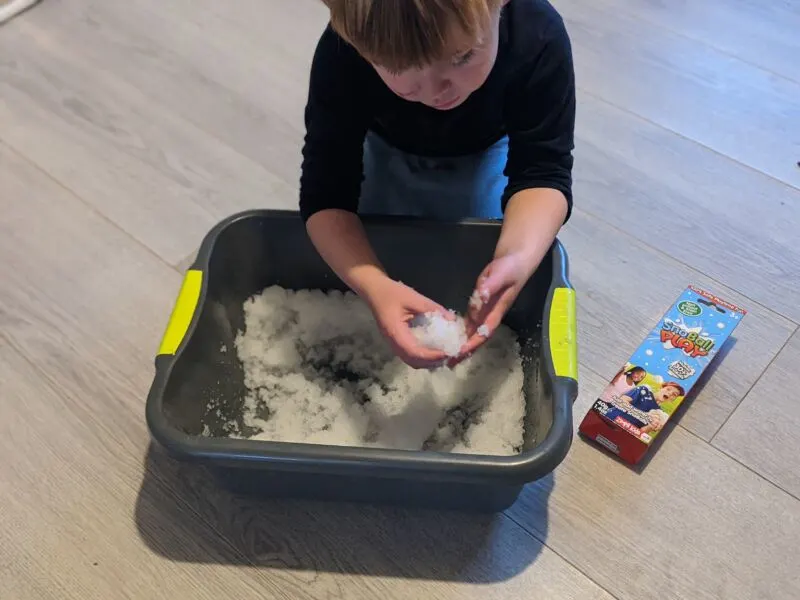 Dexter making snoballs using a washing up bowl 