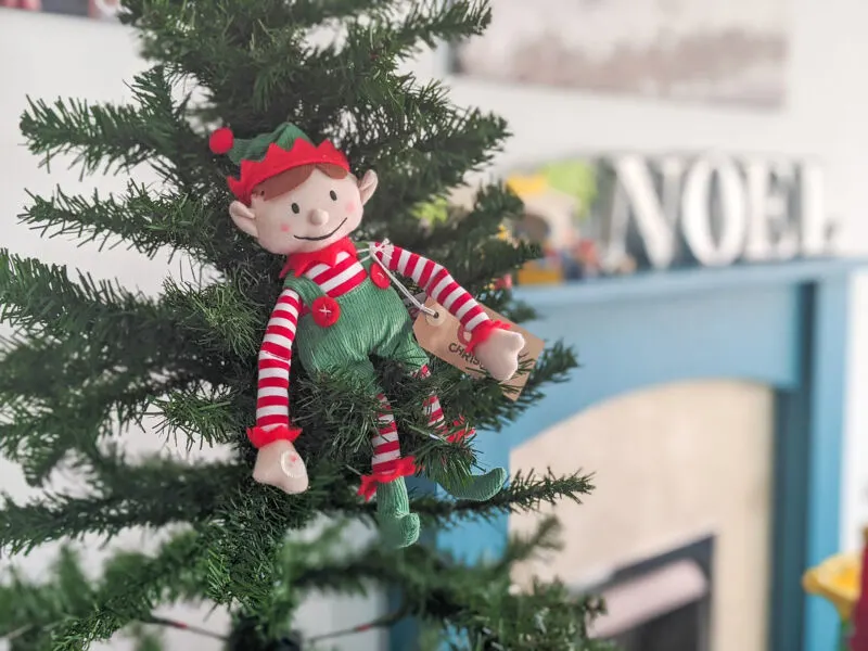 Elf for Christmas sat on the christmas tree