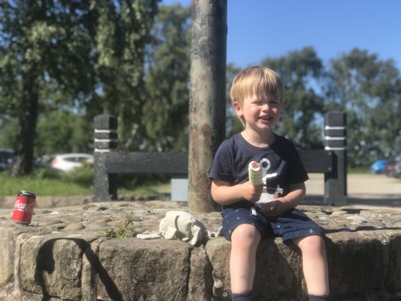 Dexter sat on a stone ledge with an ice lolly in his hand at martin mere