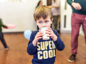 Dexter holding a cup at 4th birthday party