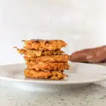 sweet potato fritters baby stacked on a plate