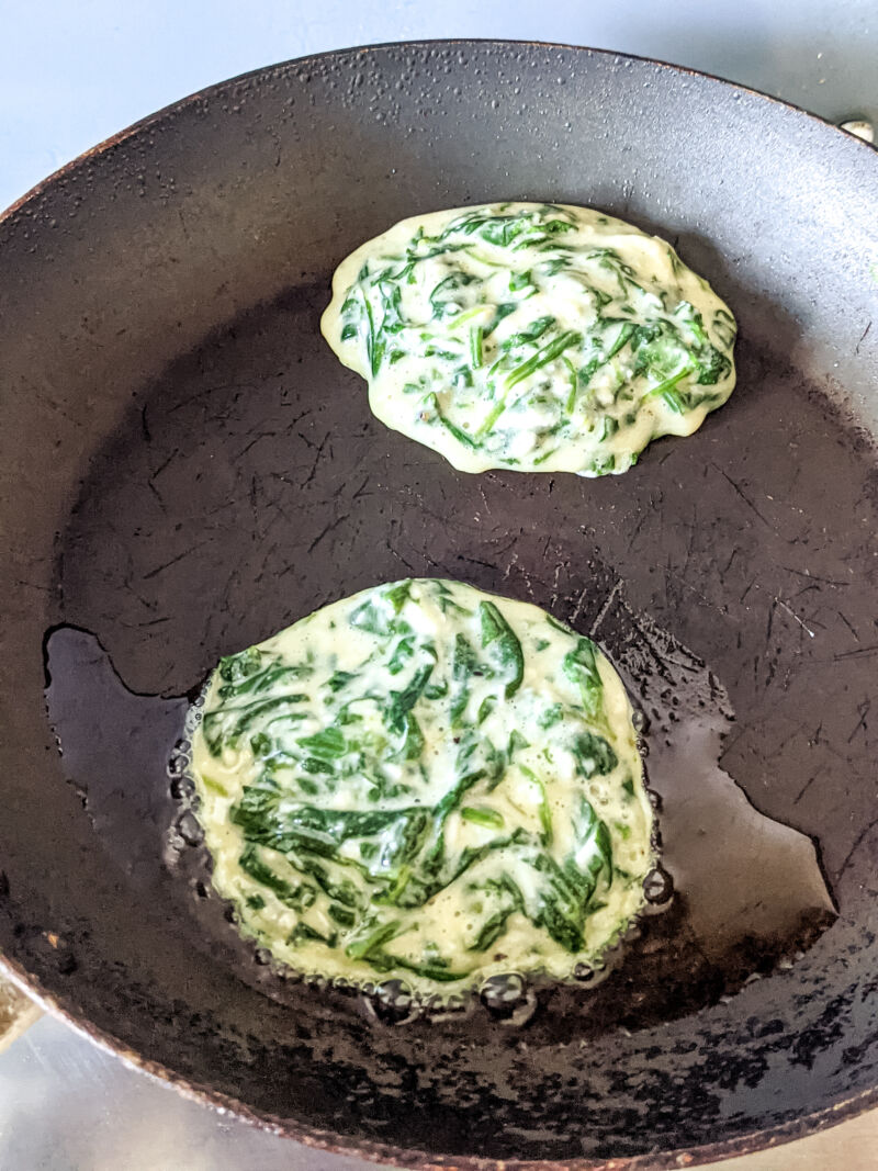 Spinach fritters for babies cooking in the pan
