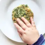 Felix touching the spinach fritters baby