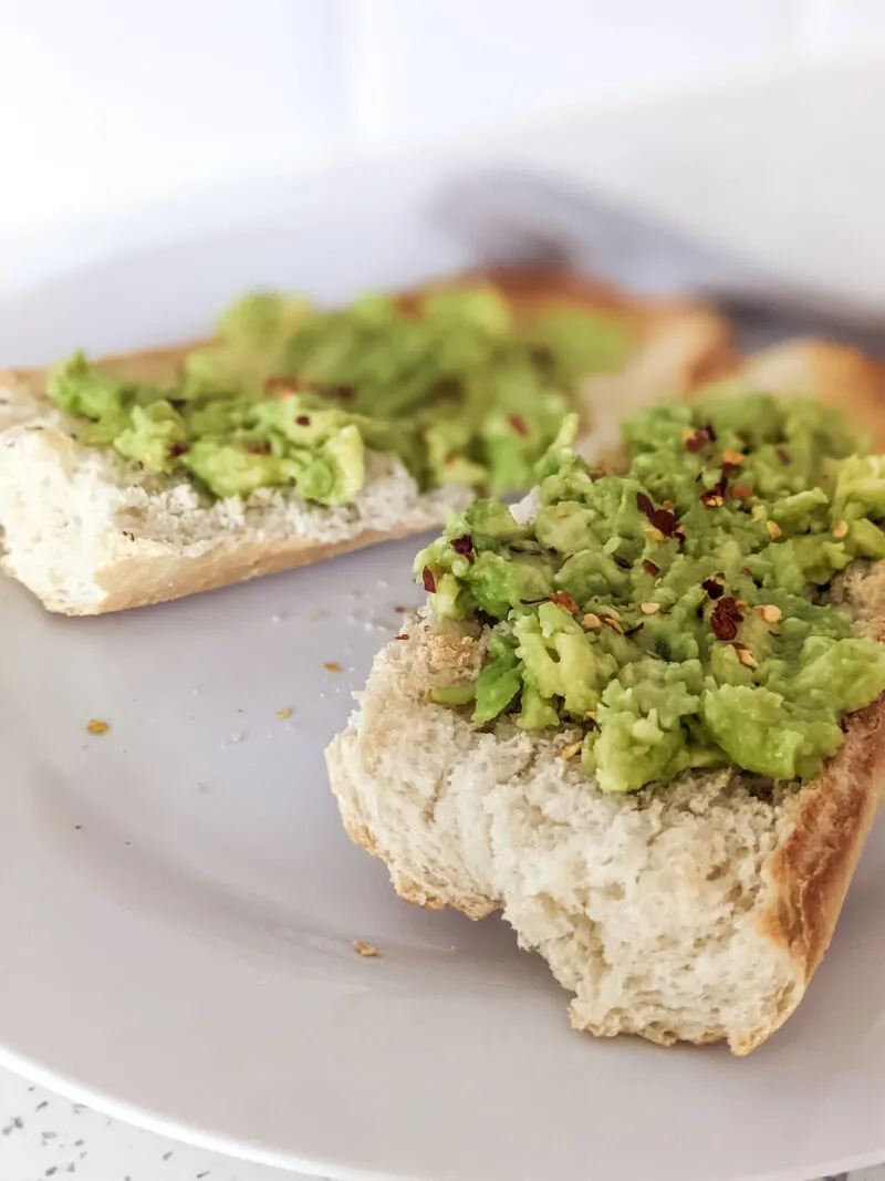 smashed avocado on baguette topped with chilli