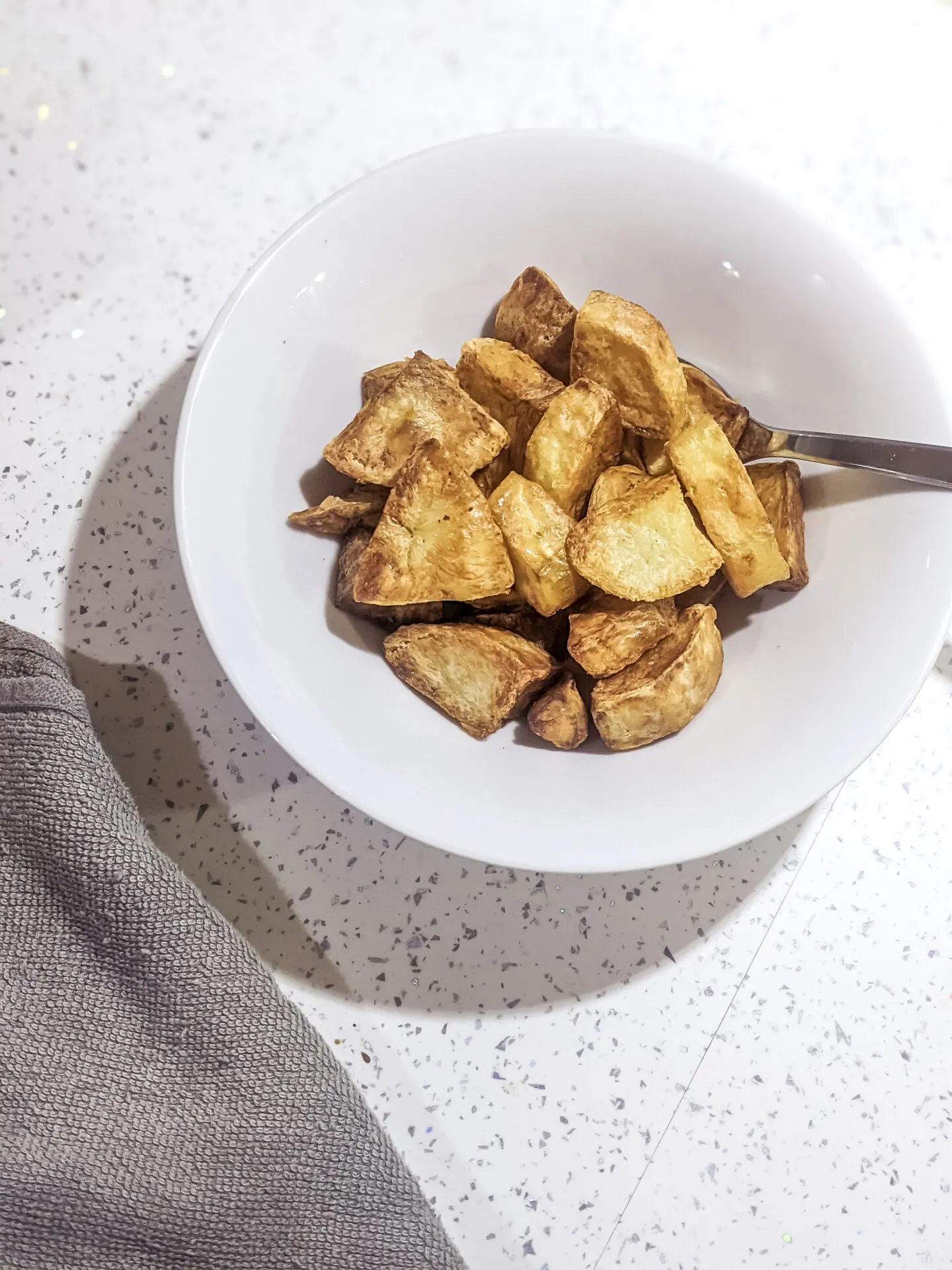 air fryer roast potatoes in white bowl