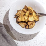 air fryer roast potatoes in white bowl