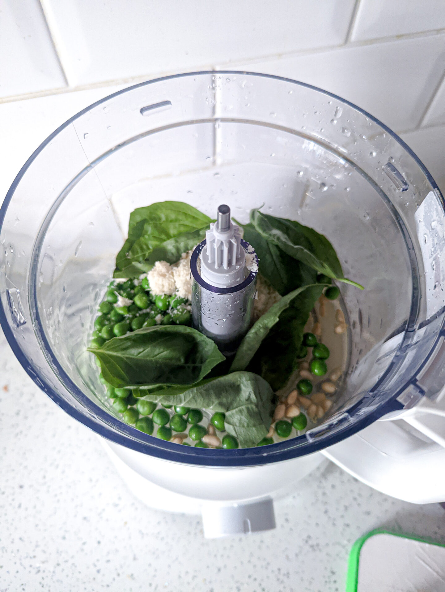 all the ingredients for baby pea pesto in the food processor