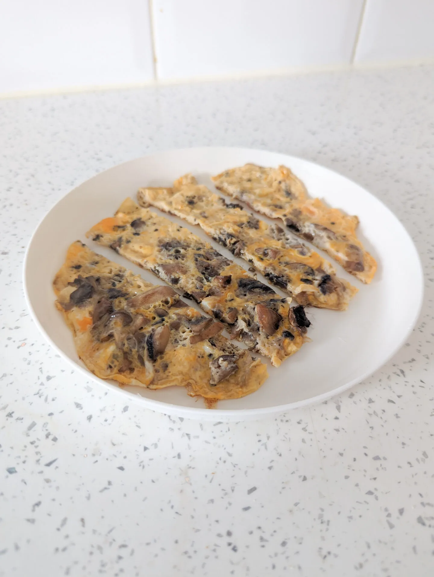 mushroom omelette for baby cut into four strips