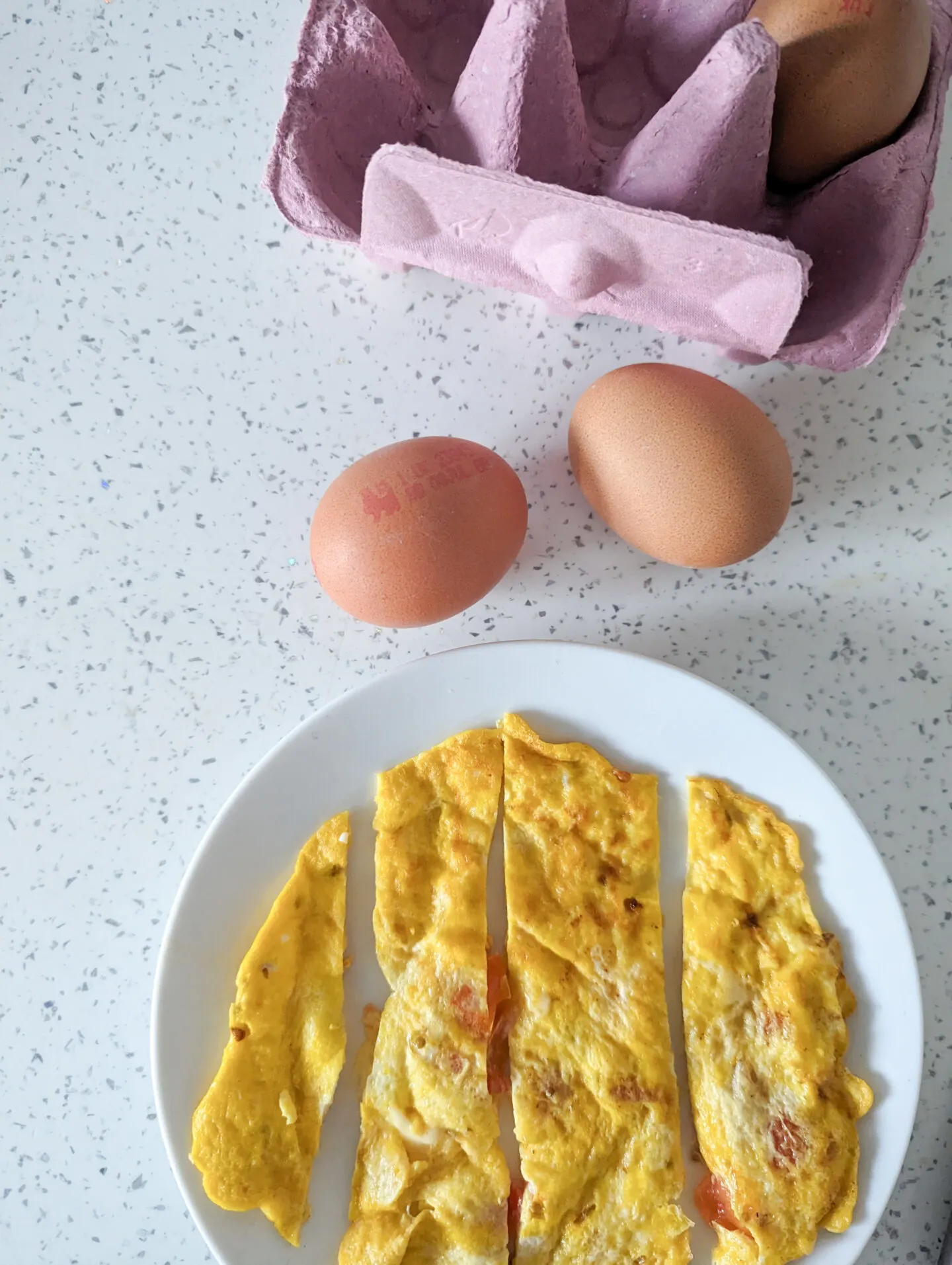 cheese and tomato omelette for babies next to eggs