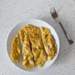 cheese and tomato omelette for baby with a fork