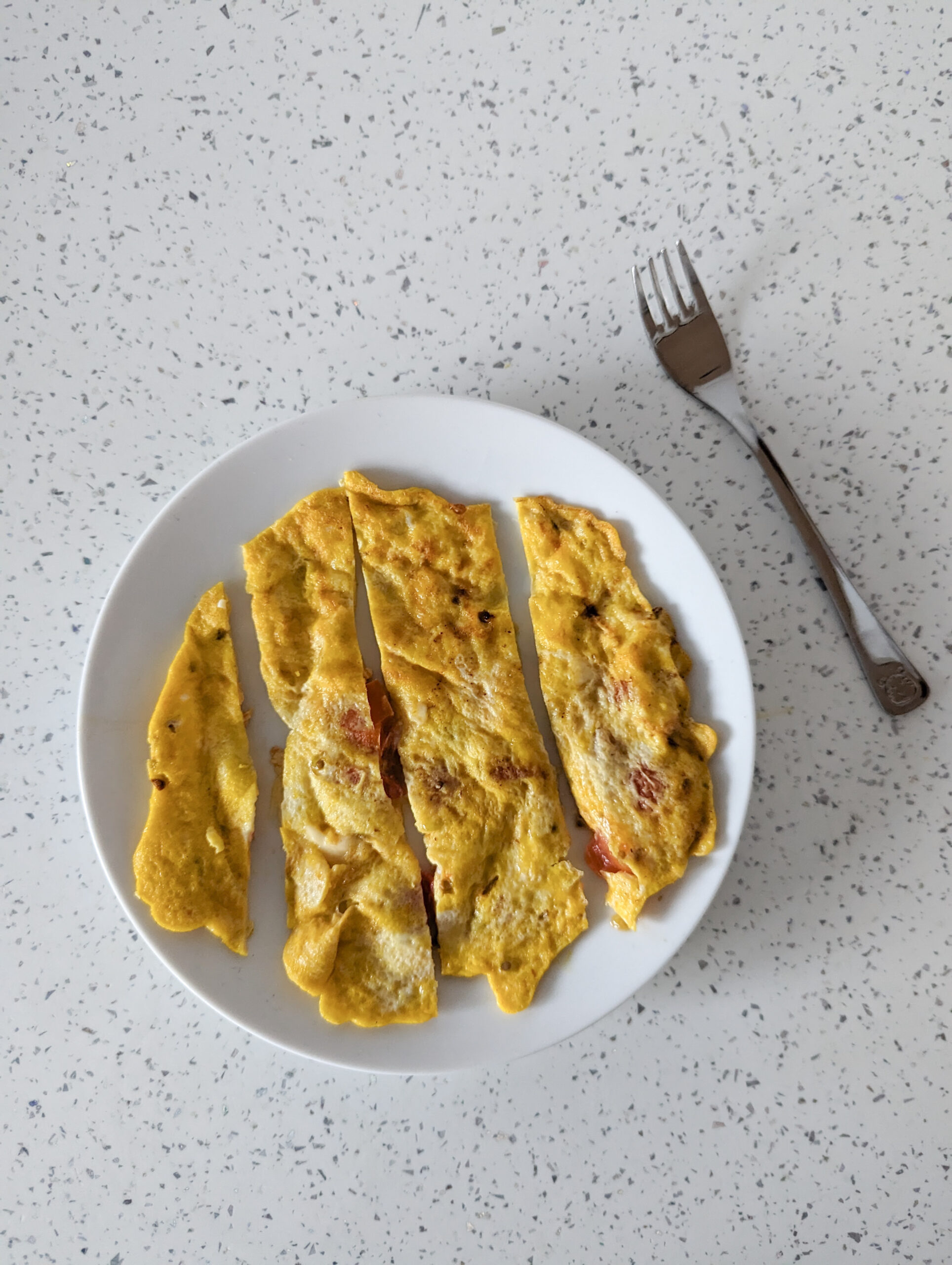 cheese and tomato omelette for baby with a fork