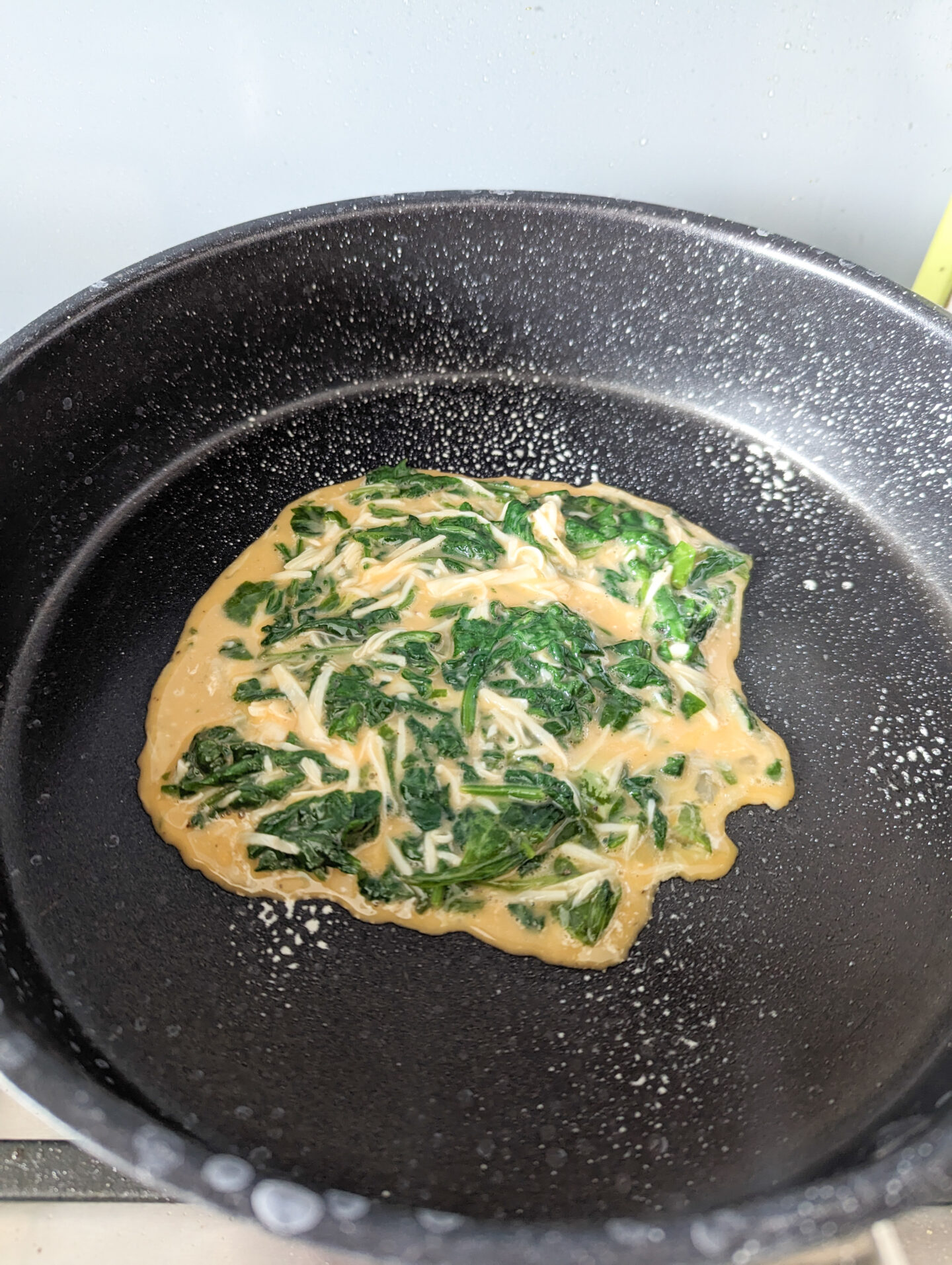spinach omelette for baby cooking in pan